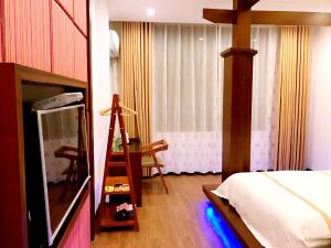 Postelja oz. postelje v sobi nastanitve Family Hotel Zhangjiajie
