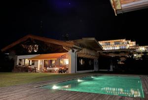 a swimming pool in front of a building at night at Kirchberg Chalet by Alpine Host Helpers in Kirchberg in Tirol