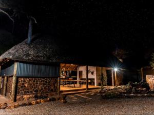 a stone building with a light at night at Thaba eNtle Private Boutique Game Farm in Thabazimbi
