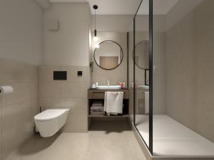 a bathroom with a toilet and a sink and a mirror at City inn Olomouc in Olomouc