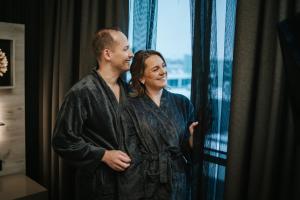 a man and a woman standing in front of a window at Tallink City Hotel in Tallinn