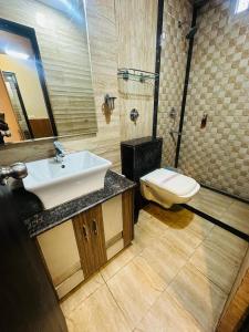 a bathroom with a sink and a toilet at HOTEL COSMOS in Lucknow