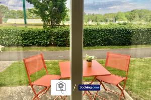 two orange chairs and a table with a potted plant at Garden Apartment near New Forest By Your Stay Solutions Short Lets & Serviced Accommodation Netley Southampton With Free Wi-Fi in Totton