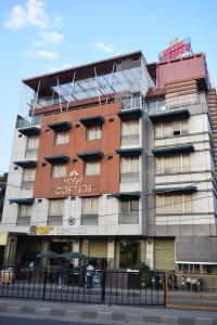 a building with a sign on the side of it at HOTEL COSMOS in Lucknow