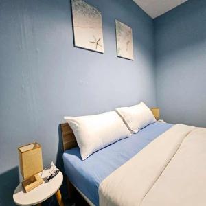 a bedroom with a bed and a table with a nightstand at House of sea Jomtien beach in Jomtien Beach