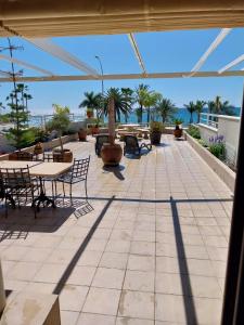 a patio with tables and chairs and the ocean at Home4Holidays in Nerja