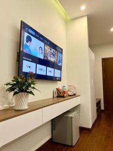 a large flat screen tv on a wall in a room at SAFFRON Dalat in Da Lat