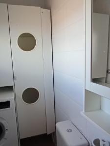 a small bathroom with a toilet and a mirror at Arrabassada in Tarragona