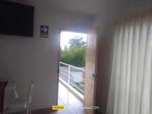 a room with a door leading to a balcony at Wayra Hospedaje in Cajamarca