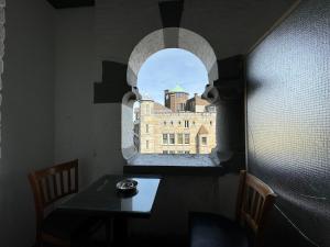 a room with a table and a window with a building at Di-Ann City Centre Hotel in Amsterdam