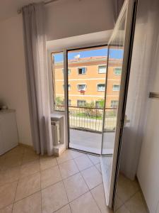 a room with a balcony with a view of a building at Appartamento La Mola in Varazze