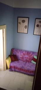 ein Schlafzimmer mit einem Bett mit einer lila Decke in der Unterkunft Little Moon in Fontana Liri