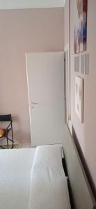 a bedroom with a bed and a white cabinet at Little Moon in Fontana Liri