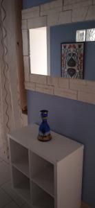 a blue vase sitting on a white table in a room at Little Moon in Fontana Liri