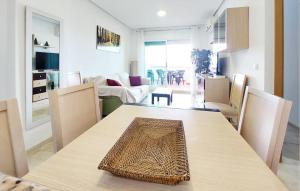 a living room with a wooden table and chairs at Stunning Apartment In Oropesa Del Mar in Oropesa del Mar