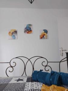 1 cama con cabecero negro con fotos en la pared en Afionas Cottage, en Afionas