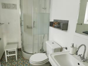 a bathroom with a shower and a toilet and a sink at Fährhaus Wittower Fähre in Wiek auf Rügen