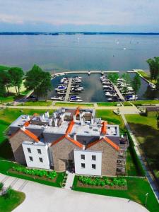an aerial view of a large house with a marina at Nautica Resort in Giżycko