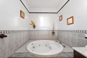 a bathroom with a large tub in a room at Casa Rural Tijoco by Paramount Holidays in Adeje +29 photos