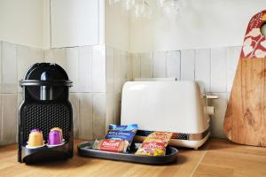 a tray of food on a counter next to a toaster at Suite Haussmann by Les Maisons de Charloc Homes in Paris