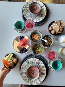 a table with plates and bowls of food on it at soulrebel rio - Vegan Retreat & SPA in Rio de Janeiro