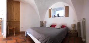 a bedroom with a bed and a mirror in a room at Mas des Clauzals in Le Cros