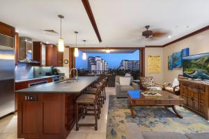 a kitchen and living room with a view of a city at Ko Olina Beach Villas O724 in Kapolei