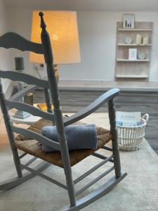a rocking chair with a lamp in a living room at Altstadt-Gästehaus mit Garten. Und Herz. in Bad Kreuznach