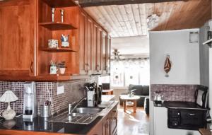 a kitchen with a sink and a refrigerator at Nice Home In Bollstabruk With House Sea View in Bollstabruk