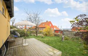 a wooden deck with a view of a house at 2 Bedroom Pet Friendly Home In Svaneke in Svaneke
