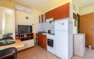 a kitchen with a white refrigerator and a table at Gorgeous Home In Benkovac in Benkovac