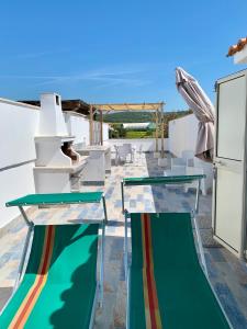 two glass tables on the roof of a house at Sunset Apartment in Santa Marinella