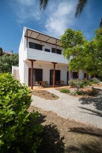 a white house with a table in front of it at MYLOS (6) in Chania