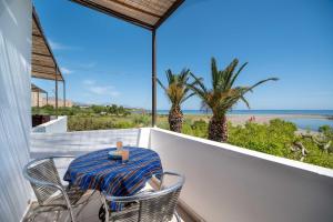 a table and chairs on a balcony with a view of the ocean at MYLOS (6) in Chania