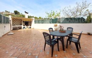a patio with a table and chairs on a patio at 3 Bedroom Cozy Home In Peñíscola in Peñíscola