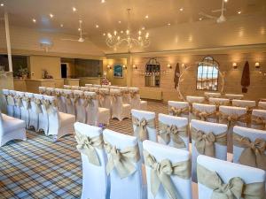 a row of chairs in a banquet hall with tables at Caley in Hunstanton