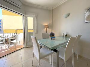 a dining room with a glass table and white chairs at Castillo de Moraira in Moraira