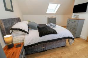 a bedroom with a large bed and a television at Cuckoo's Rest in Penryn
