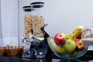 a food processor filled with cereal and fruit on a counter at Hotel New House in São Paulo