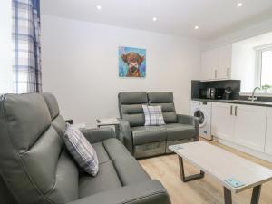 a living room with a couch and a table at 2 College Bounds in Fraserburgh