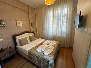 Krevet ili kreveti u jedinici u okviru objekta Hotel Buhara Family Inn