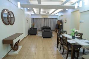 a living room with a table and a dining room at Kitengule Apartment 002 in Dar es Salaam