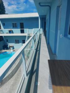 a balcony of a building with a swimming pool at Chalés Praia São Lourenço in Bertioga
