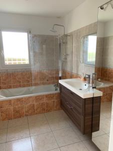 a bathroom with a tub and a sink and a shower at Maison proche Hossegor in Tosse +27 photos