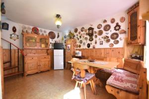 a kitchen with a table and plates on the wall at Casa Canale in Tonezza del Cimone