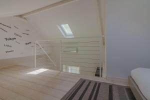 a bedroom with a bed and a skylight at Pretty Home Varenna in Varenna +38 photos
