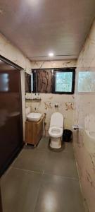 a small bathroom with a toilet and a sink at Hotel Freedom Star ReTreat in Mumbai