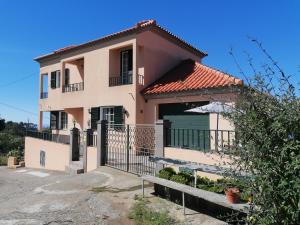 a house with a gate in front of it at Abrigo do Monte in Ribeira Brava