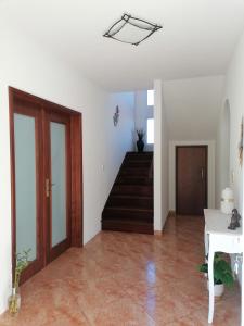 a room with a hallway with a staircase and a door at Abrigo do Monte in Ribeira Brava