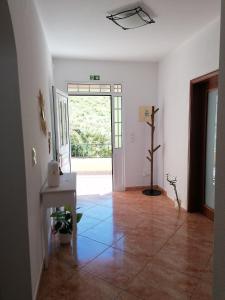 a room with a hallway with a door and a plant at Abrigo do Monte in Ribeira Brava +56 photos